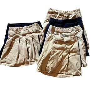 4 cream and 2 blue girls uniform skirts from The children’s place.